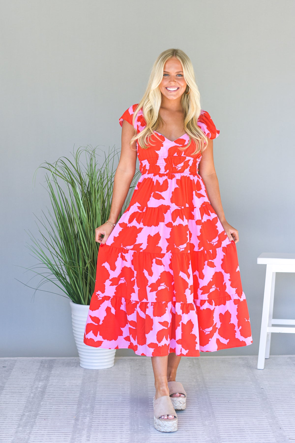 neon pink maxi dress with bright red floral print 