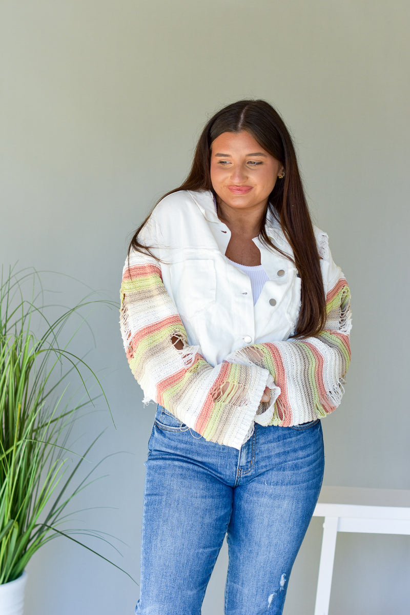 White button up denim jacket with striped knit sleeves