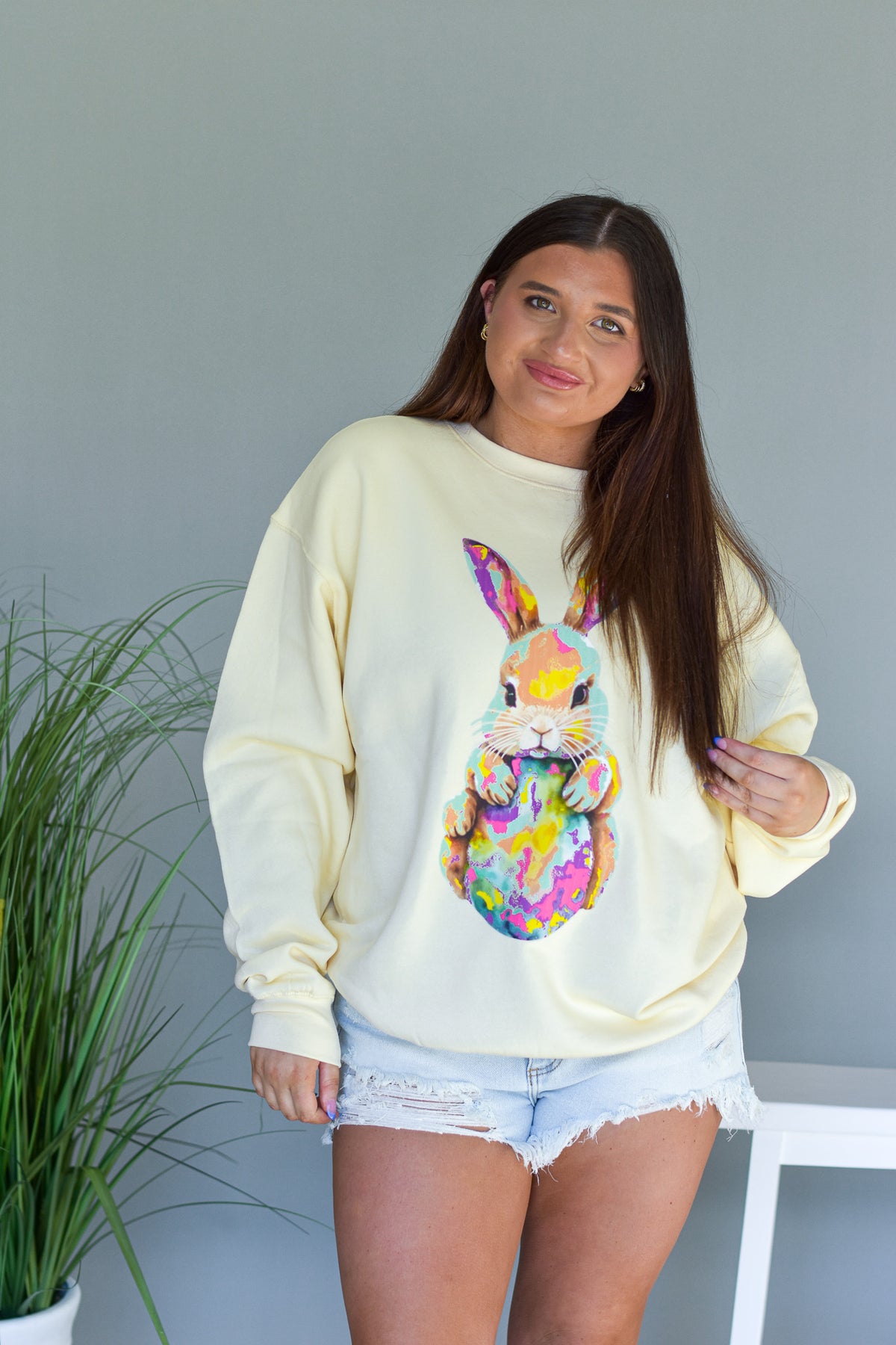 Pastel yellow sweatshirt with easter bunny graphic