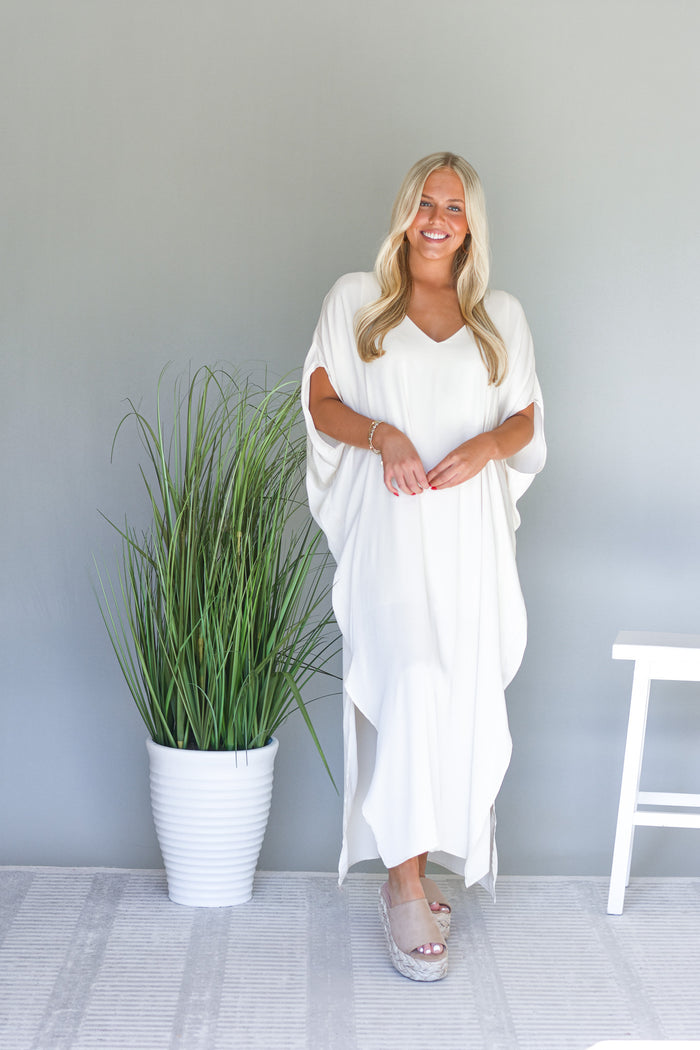 flowy cream maxi dress with oversized sleeves and side slit detail