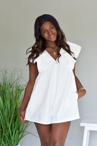 white denim baby doll style romper with v neckline and flutter puff sleeves