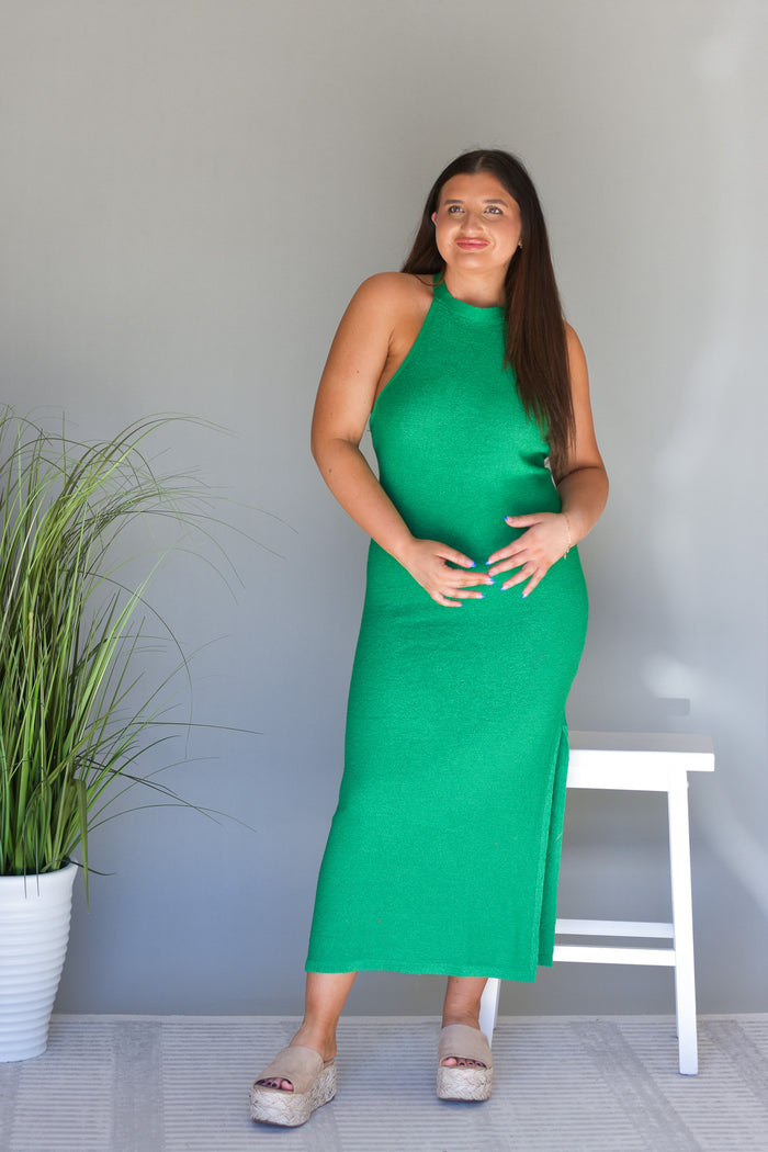 green knit maxi dress with a halter neckline and side slits