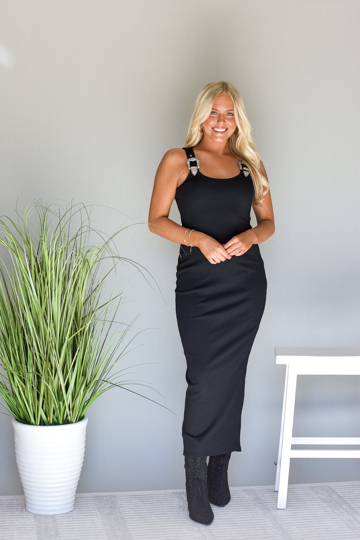 black stretch knit maxi dress with western buckle detail at shoulders
