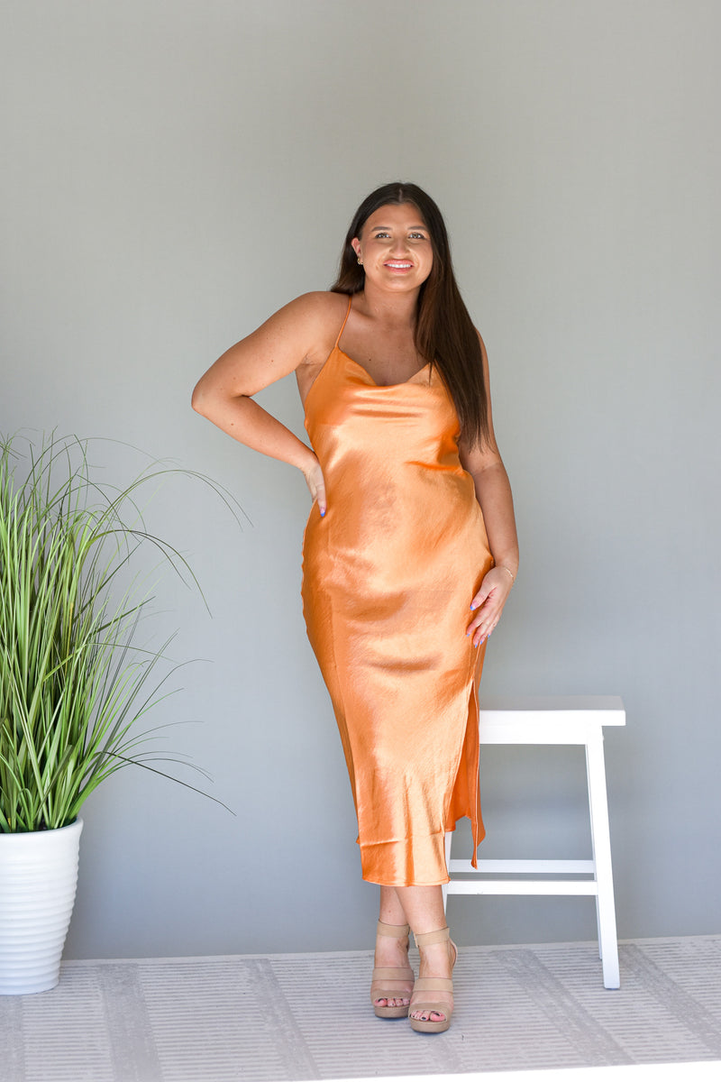 orange satin silk midi dress with cowl neckline and adjustable straps on back side slit