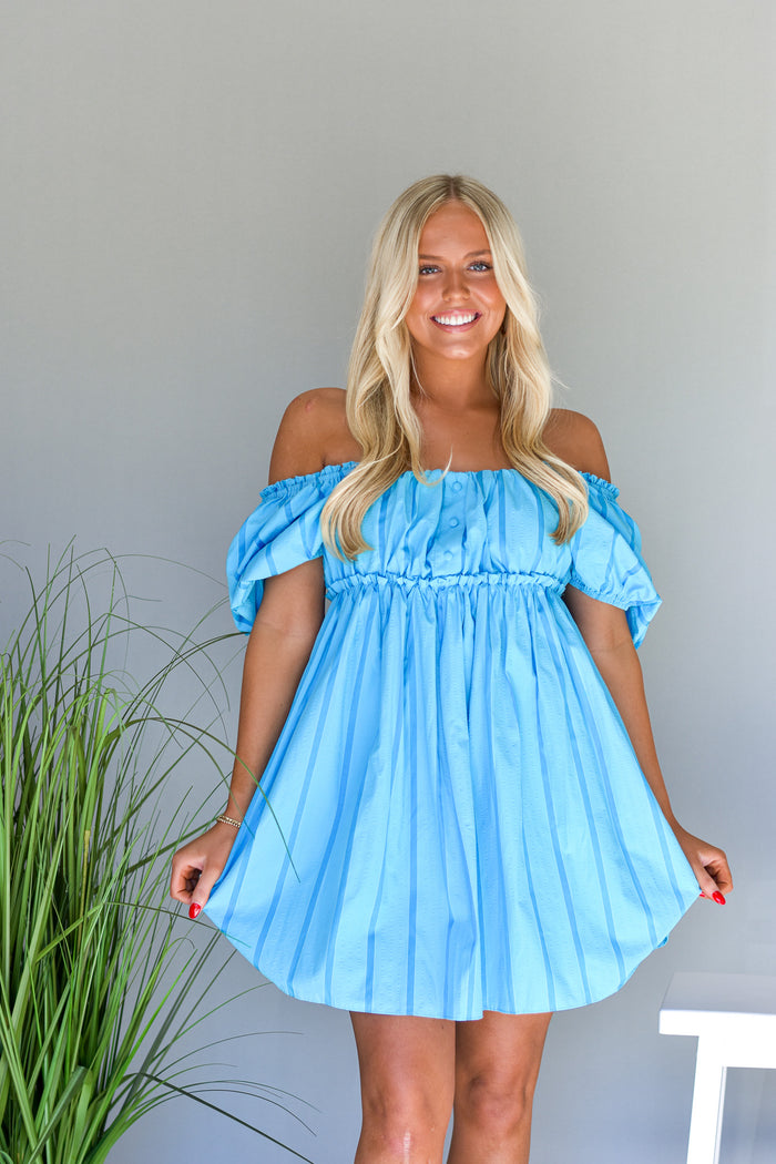 blue baby doll style mini dress with puff sleeves and a pinstripe print