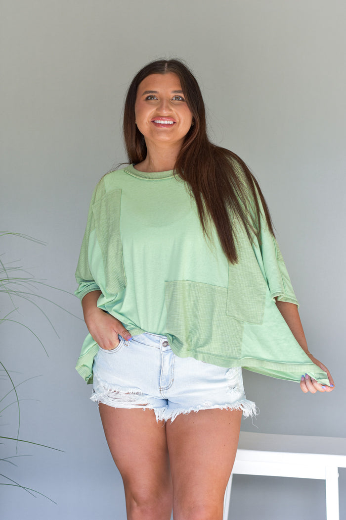 oversized flowy top with patch work detail in sage